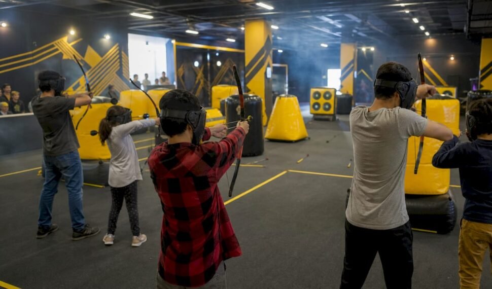 Family playing combat archery indoors