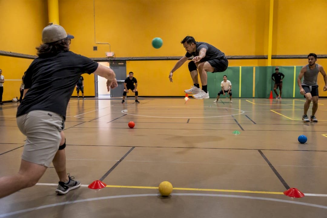 Indoor dodgeball players mid-action