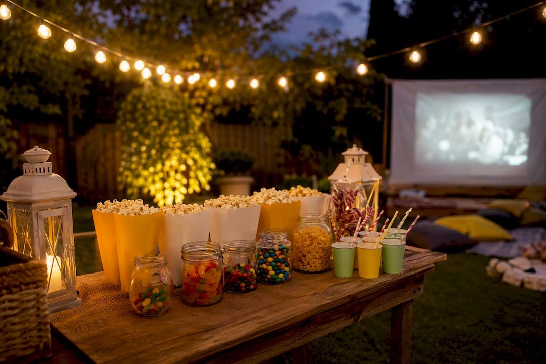 Backyard movie night setup with concession boxes