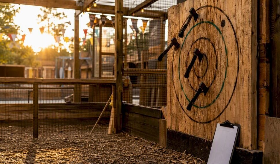 Axe target board with axes embedded indoors