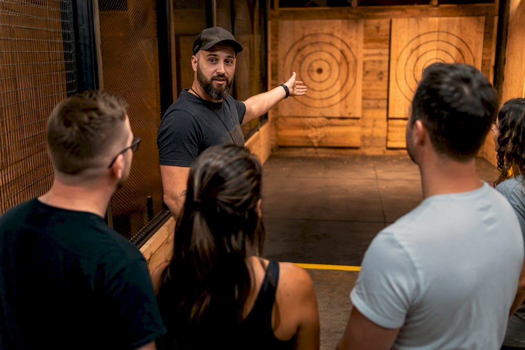 Instructor briefing private axe throwing group