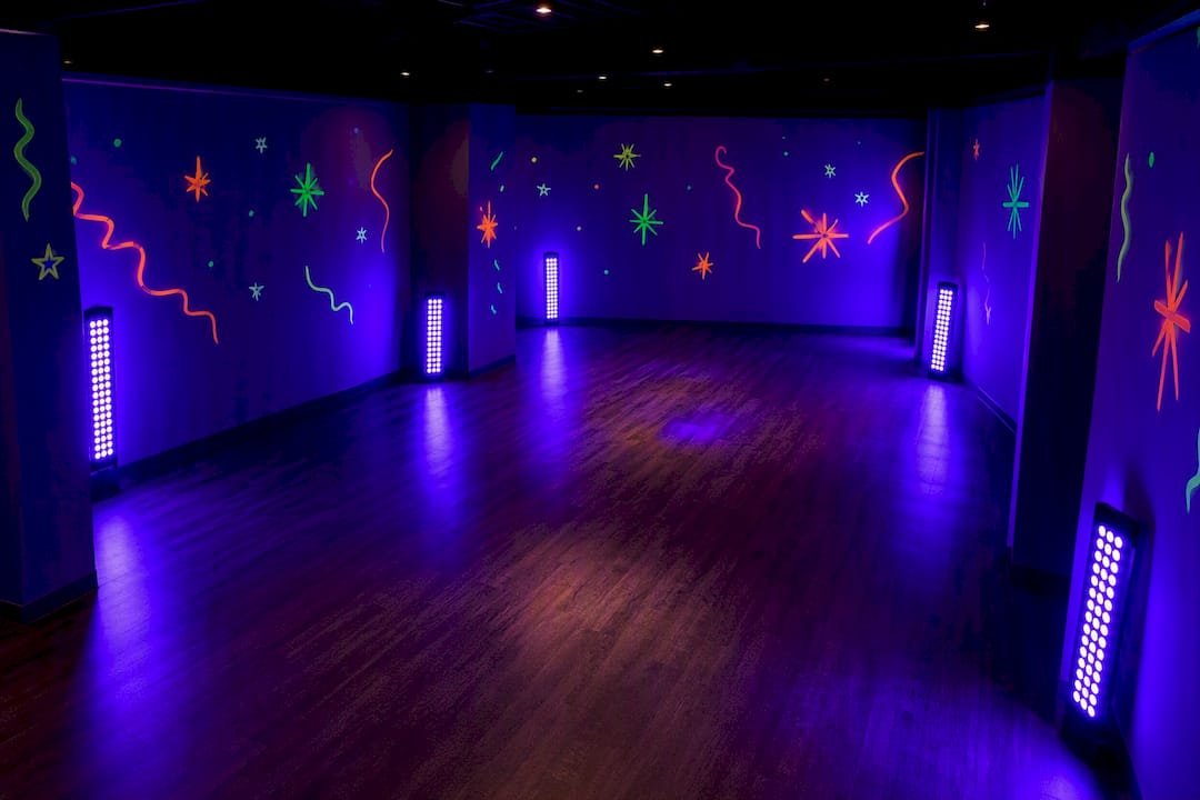 Blacklight panels arranged around party room