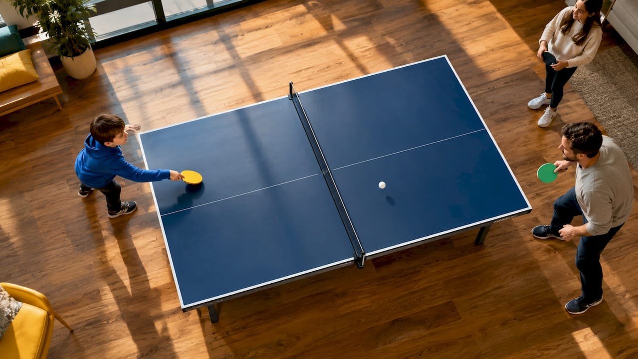 Child and adult playing inclusive ping pong