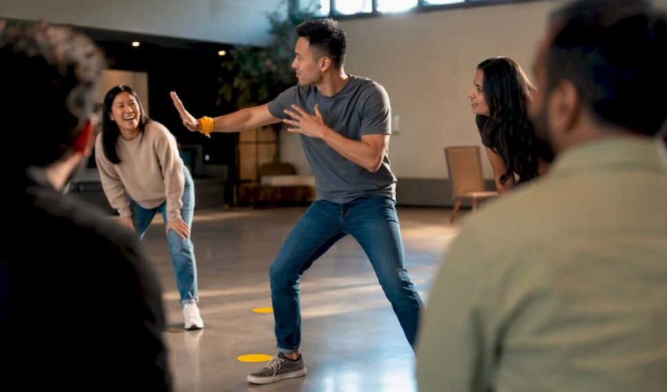 Adults playing a charades communication game