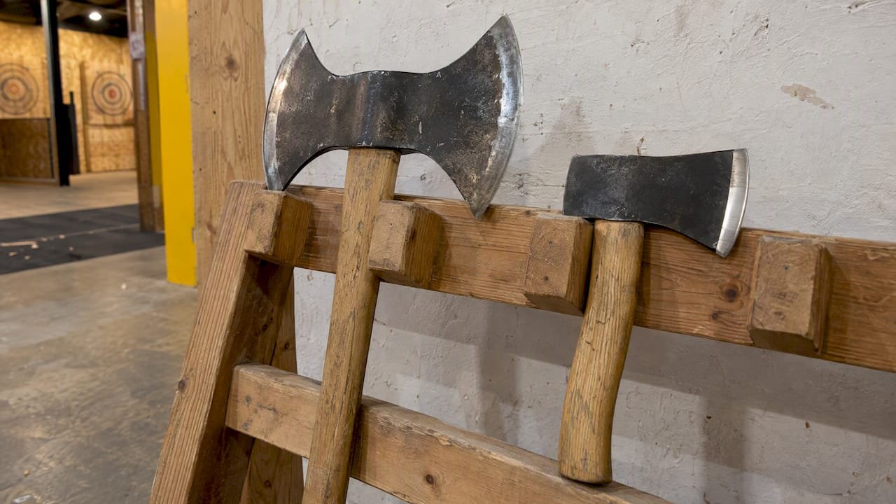Double-bit axe beside single-bit hatchet