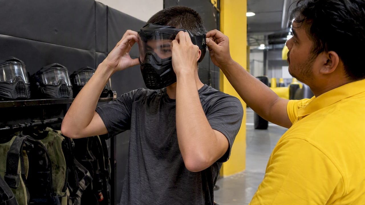 Player checking protective mask fit before a game