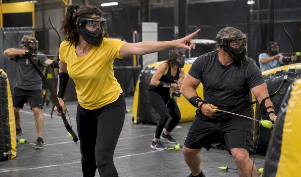 Coworkers coordinating during a combat archery game
