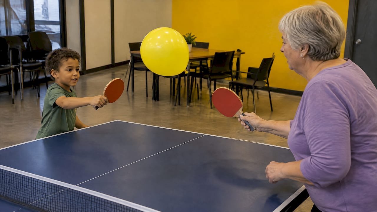 Grandmother and child playing balloon ping pong