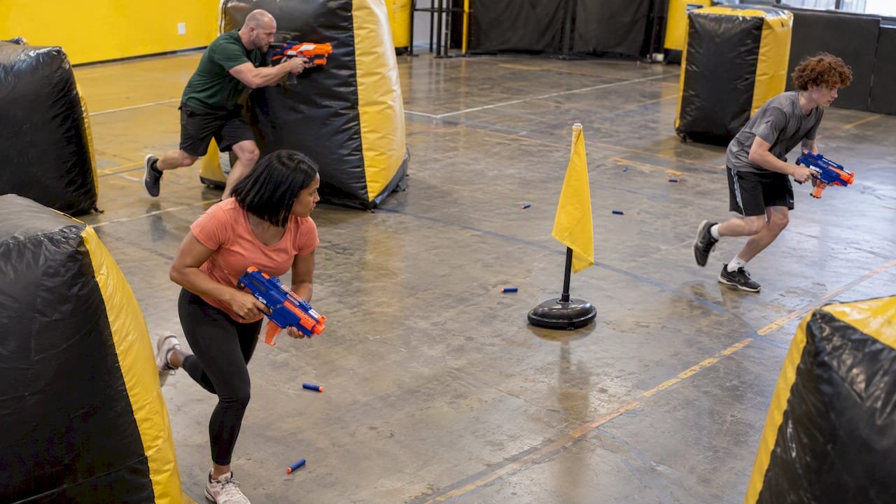 Players rushing toward a capture-the-flag marker