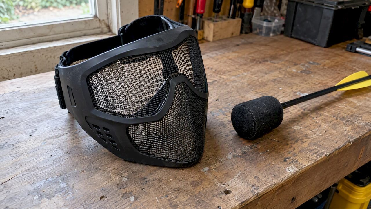 Mesh mask and foam arrow on a workbench